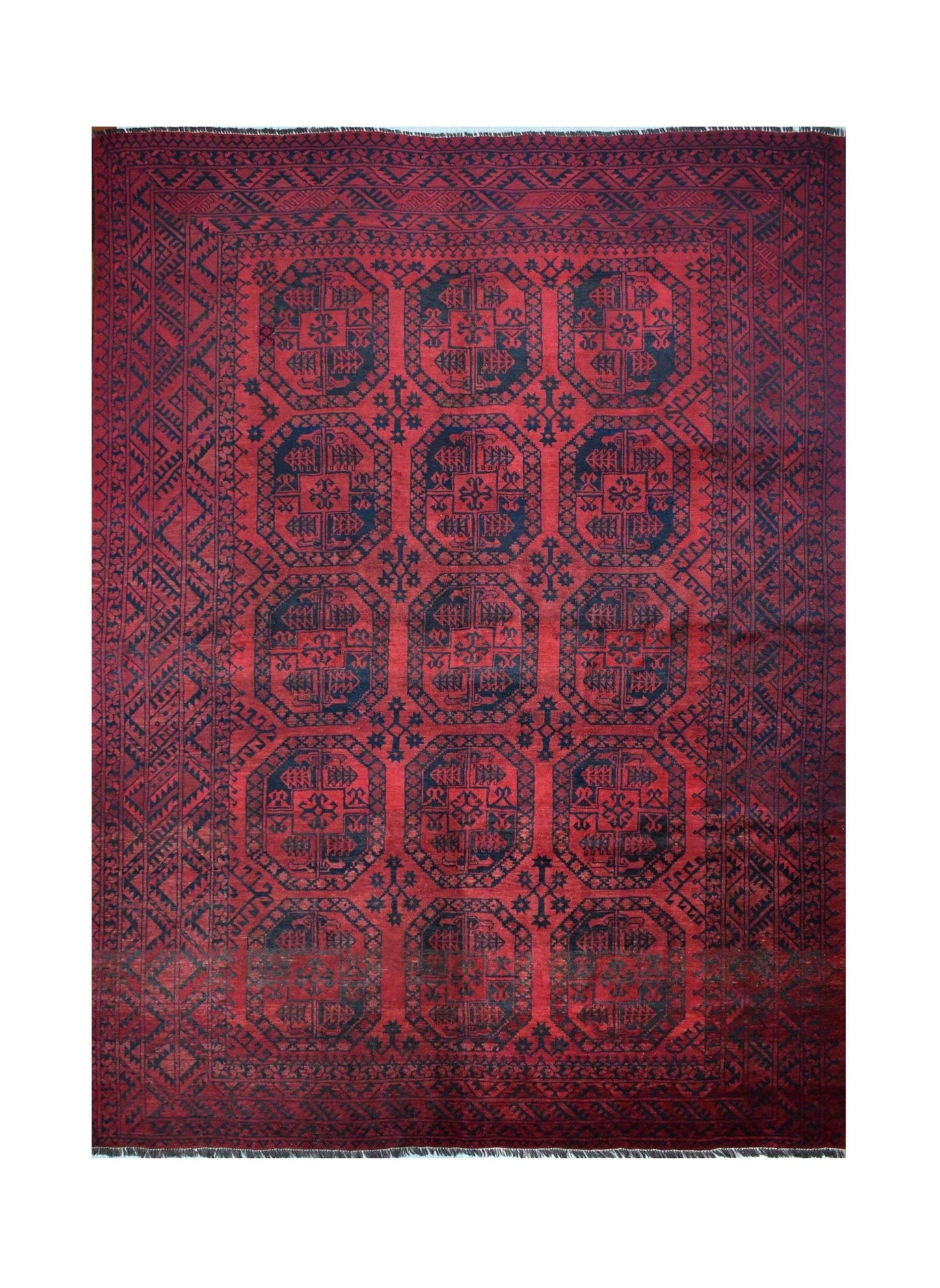 A vintage handmade Afghan Turkmen rug featuring a repeating geometric octagonal pattern in red.