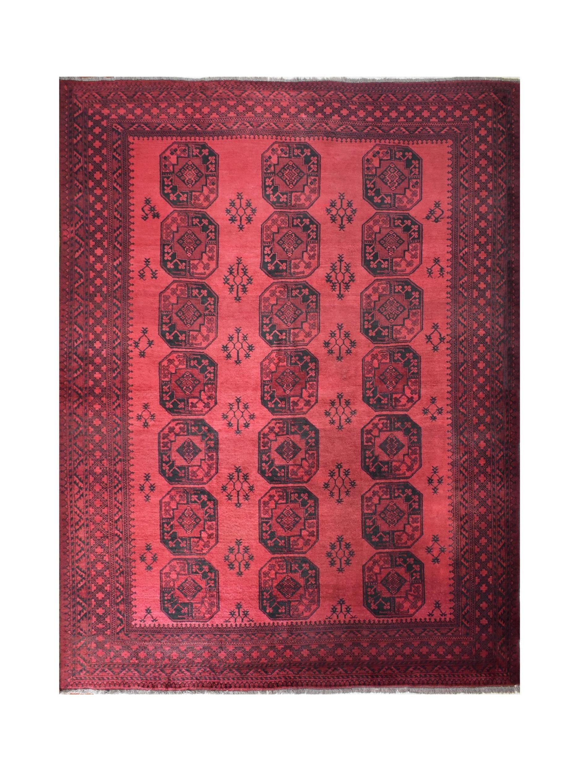 A vintage handmade Afghan Turkmen rug featuring repeating dark octagonal motifs on a red field.