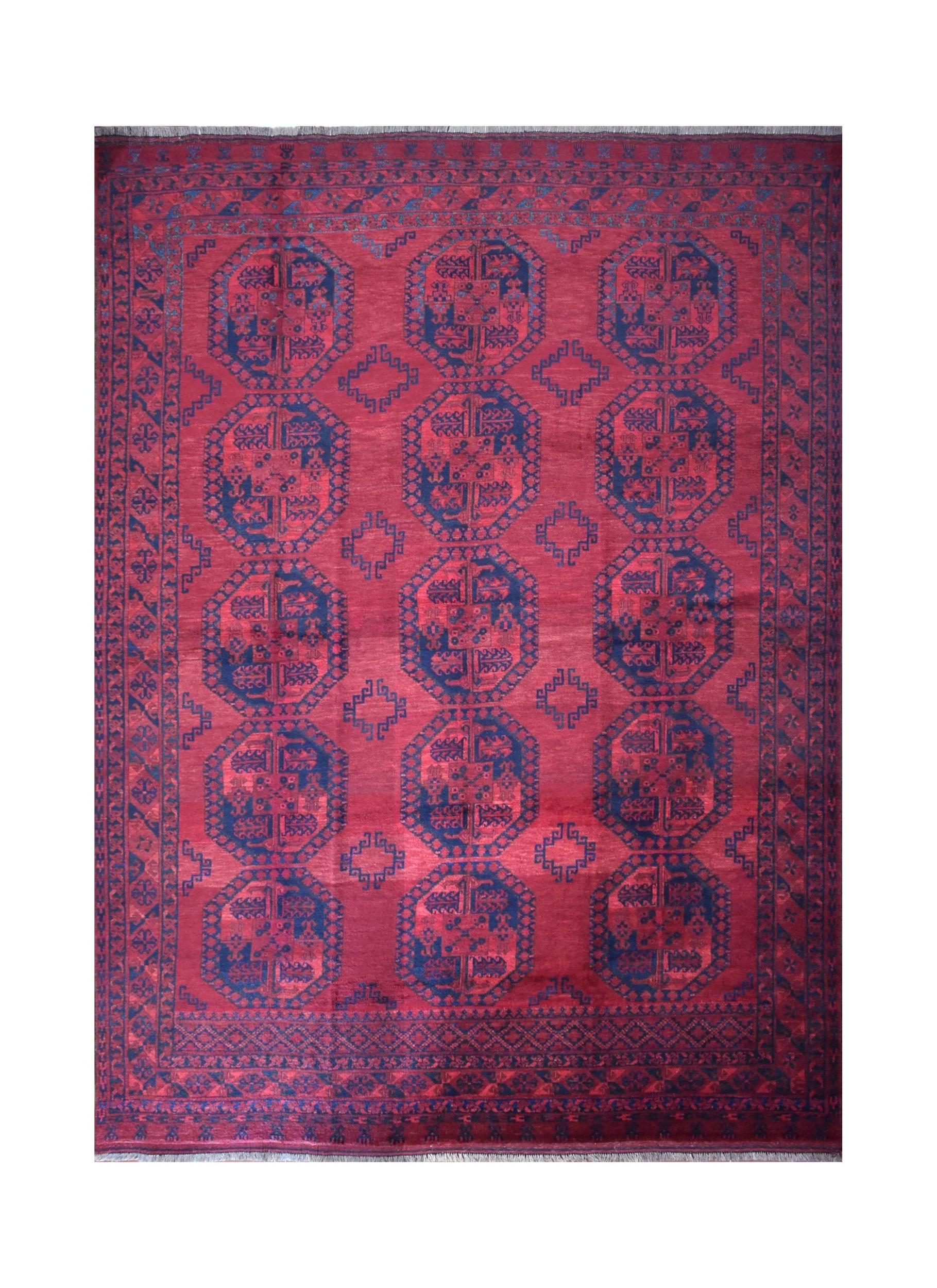 A vintage handmade Afghan Turkmen rug featuring repeating dark blue octagonal motifs on a red field.