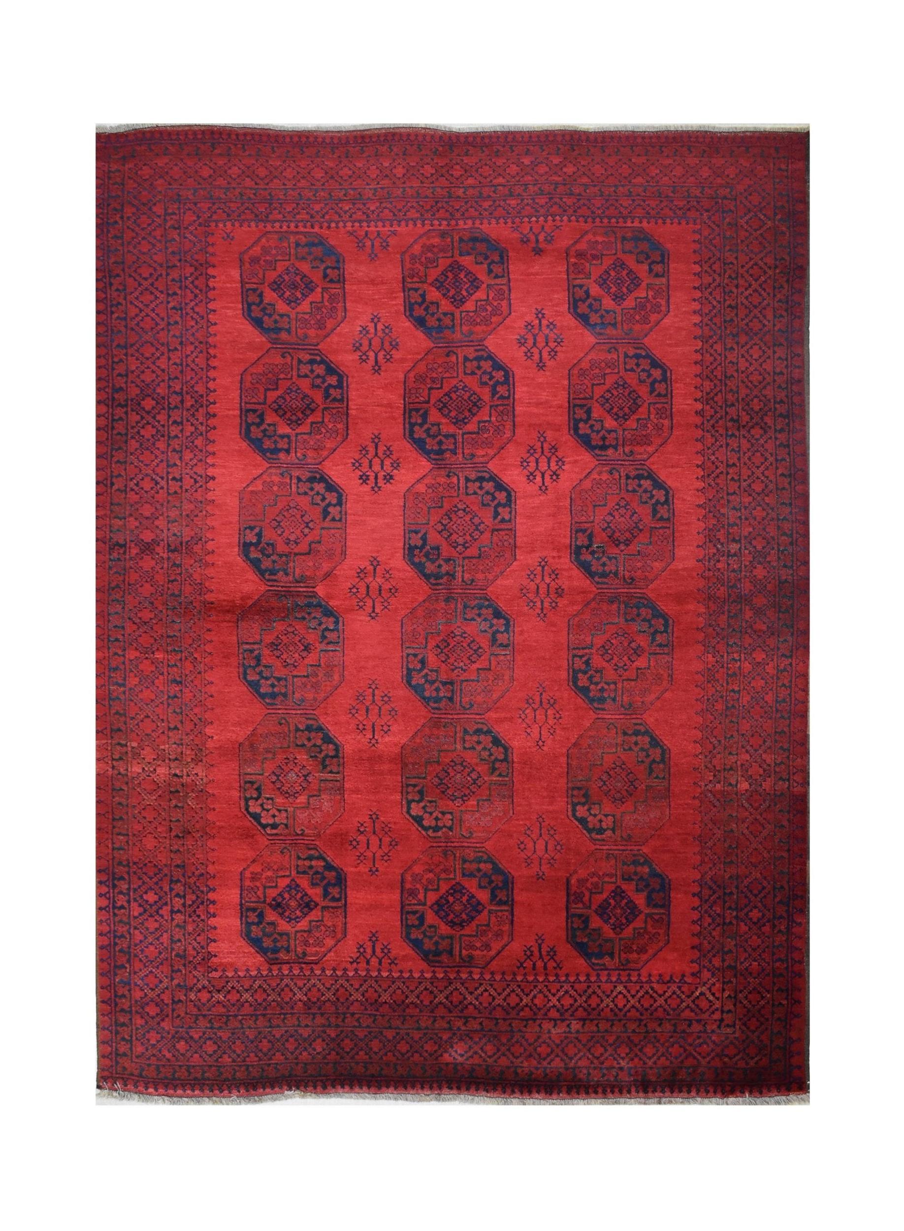 A vintage Afghan Turkmen rug featuring a repeating octagonal pattern in dark blue on a red field.