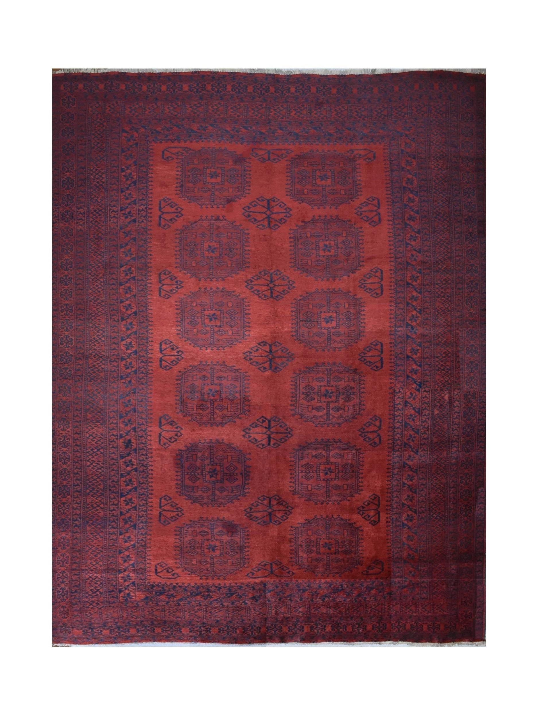 A vintage handmade Afghan Turkmen rug featuring geometric motifs in deep red and dark blue wool.