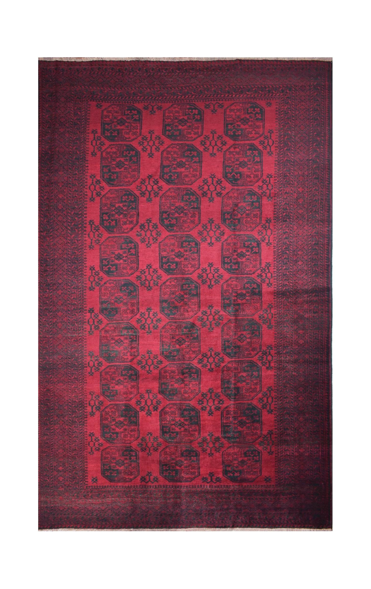 A vintage handmade Afghan Turkmen rug featuring a repeating geometric pattern in deep red and black.