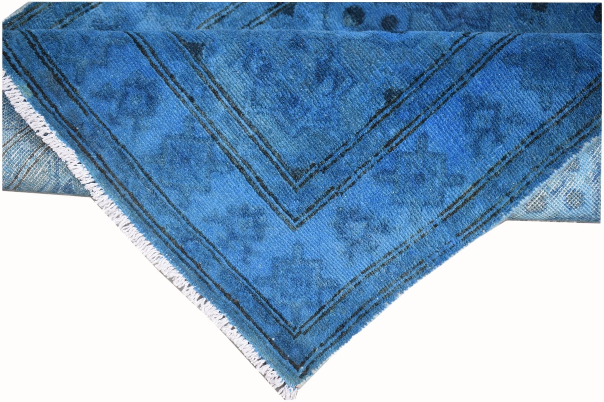 A handmade Afghan Chobi runner featuring an overdyed vibrant blue finish with subtle patterns.