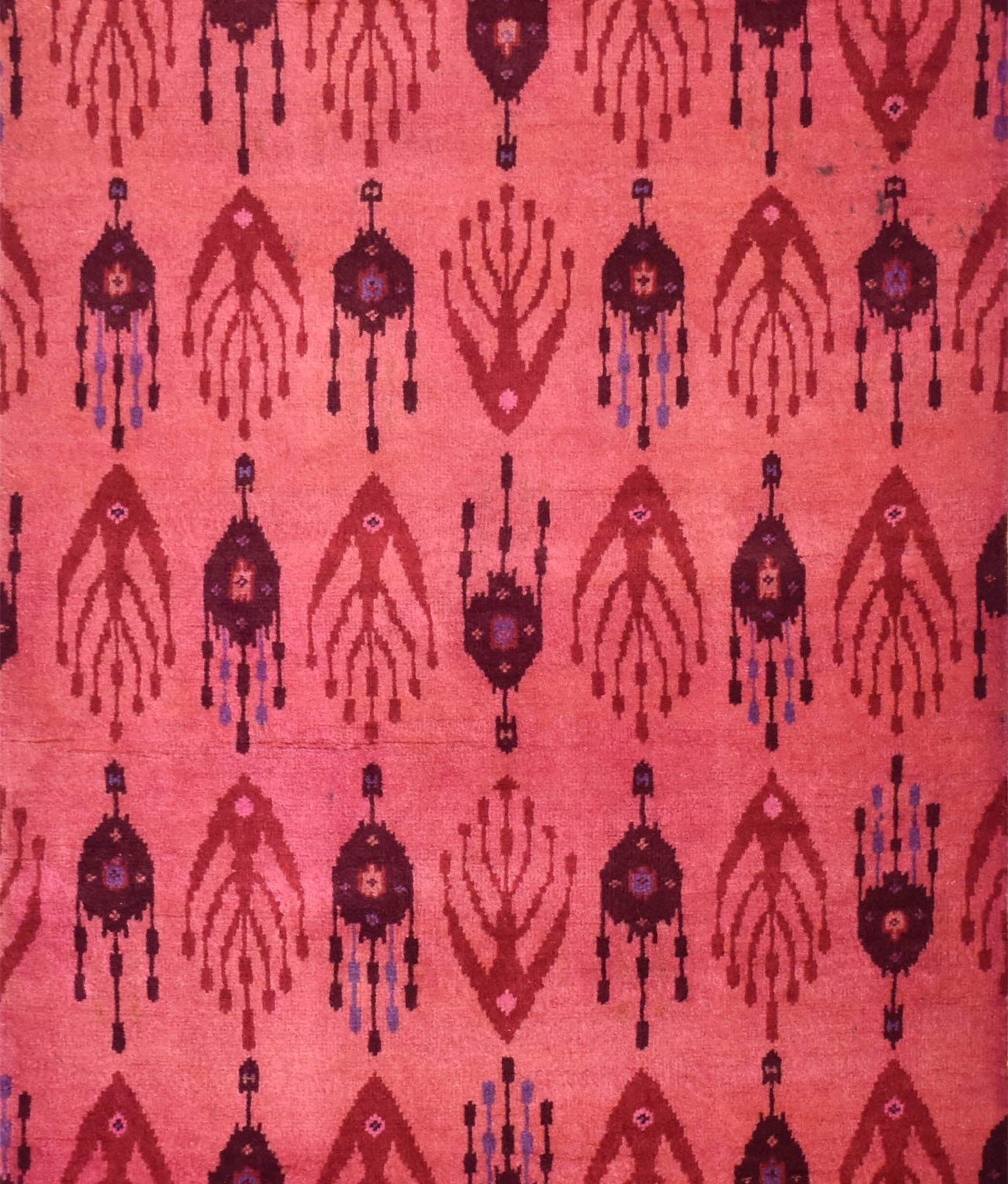 Handmade Afghan Chobi runner featuring a repeating geometric ikat pattern in shades of red.