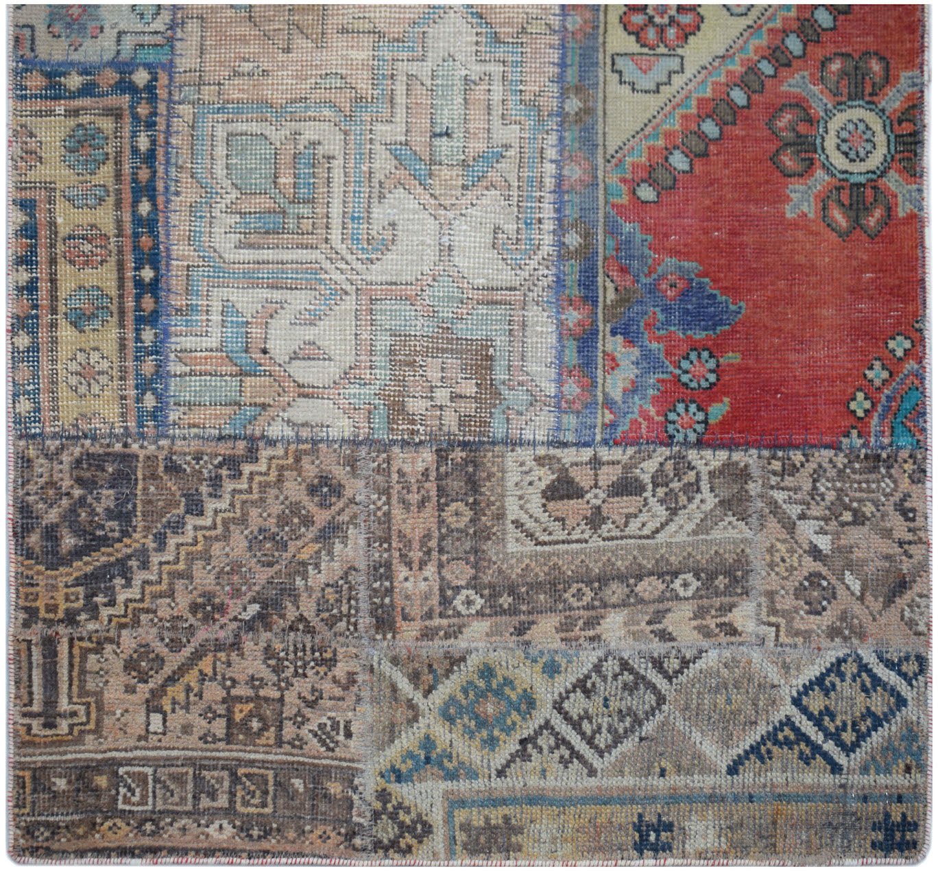 A handmade vintage patchwork runner featuring a variety of colorful, patterned wool rug fragments.