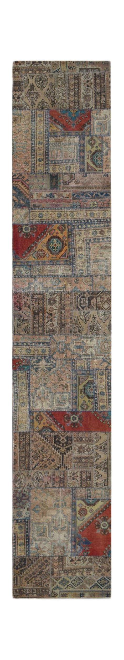 A handmade wool runner rug featuring a vintage patchwork design in muted earth tones and red.