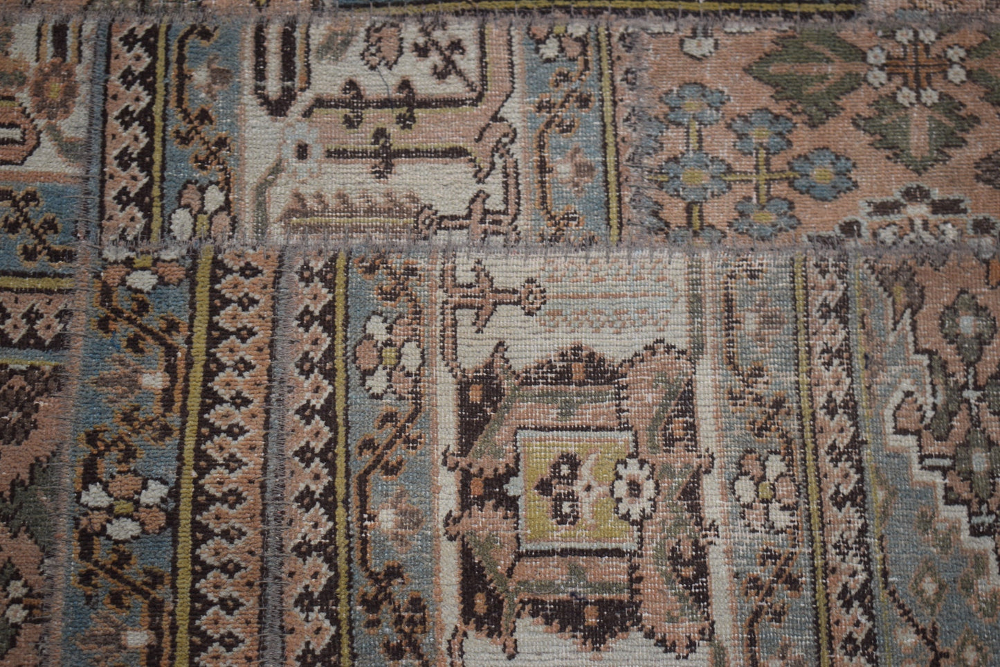 A handmade vintage patchwork runner featuring intricate floral and geometric patterns in muted tones.