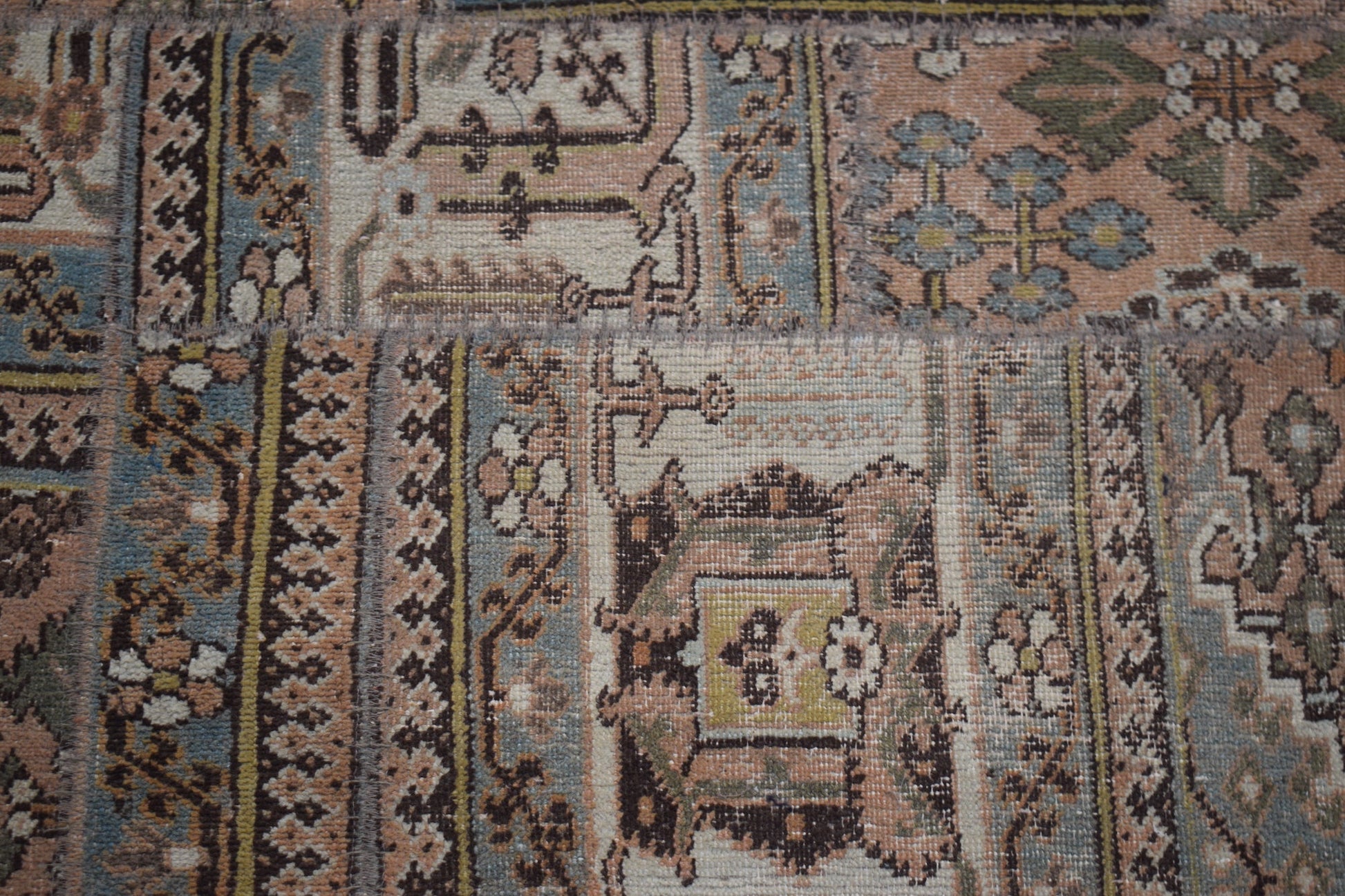 A handmade vintage patchwork runner featuring intricate floral and geometric patterns in muted tones.
