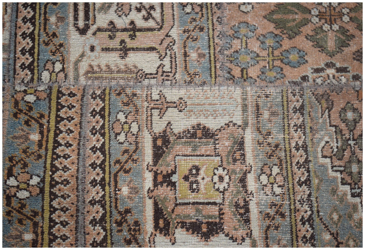 A handmade vintage patchwork runner featuring intricate wool patterns in muted earth tones.