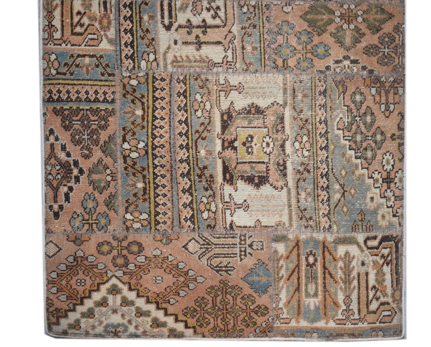 A handmade vintage patchwork runner featuring a variety of traditional patterns in muted tones.