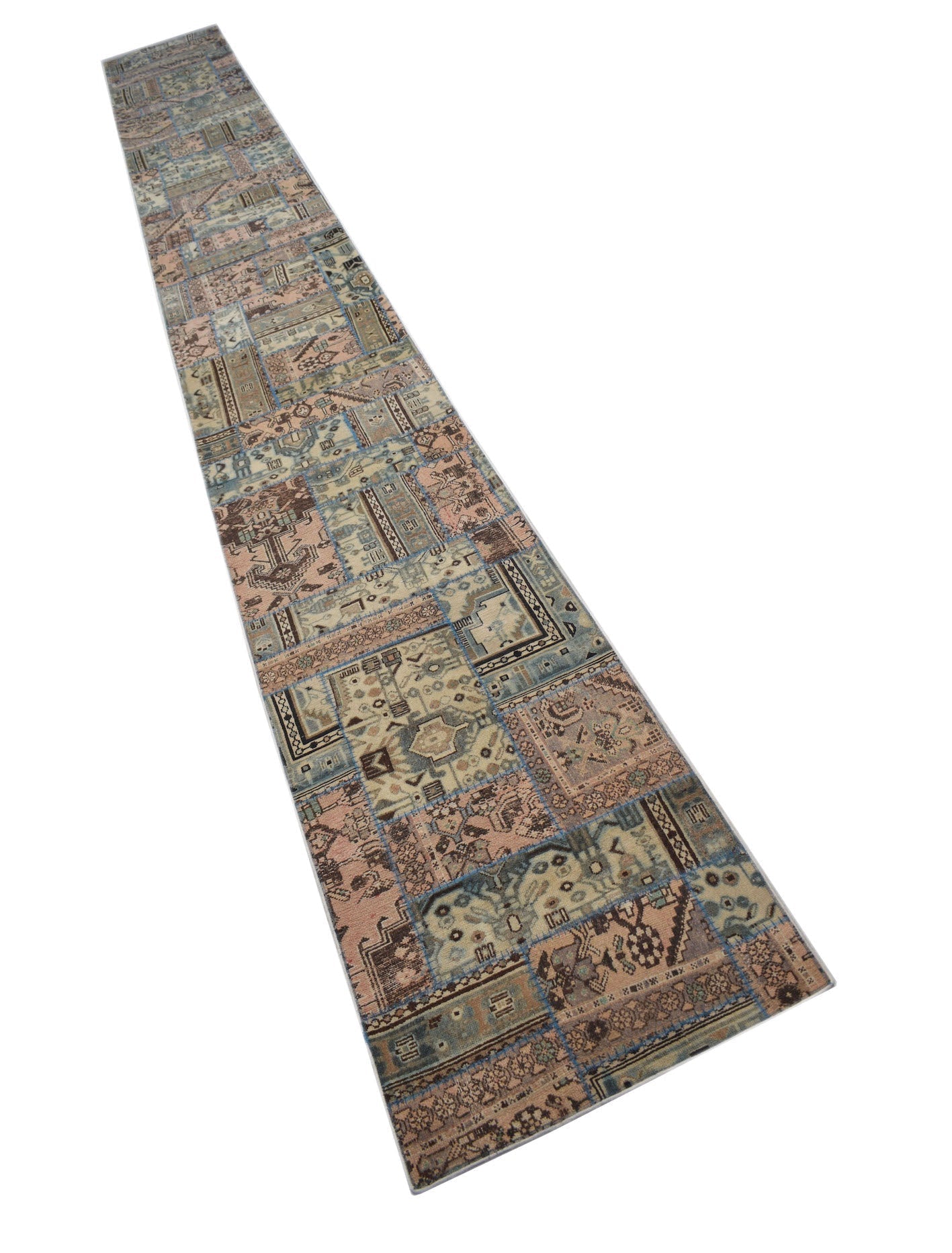 A long, handmade vintage runner rug featuring a patchwork design in muted blue and pink tones.