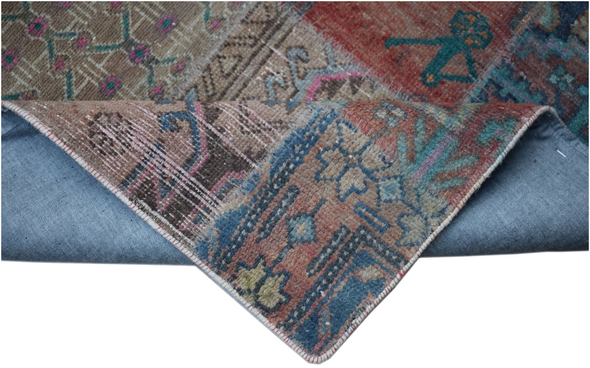 A handmade vintage patchwork runner featuring a wool pile on a cotton base with colorful patterns.