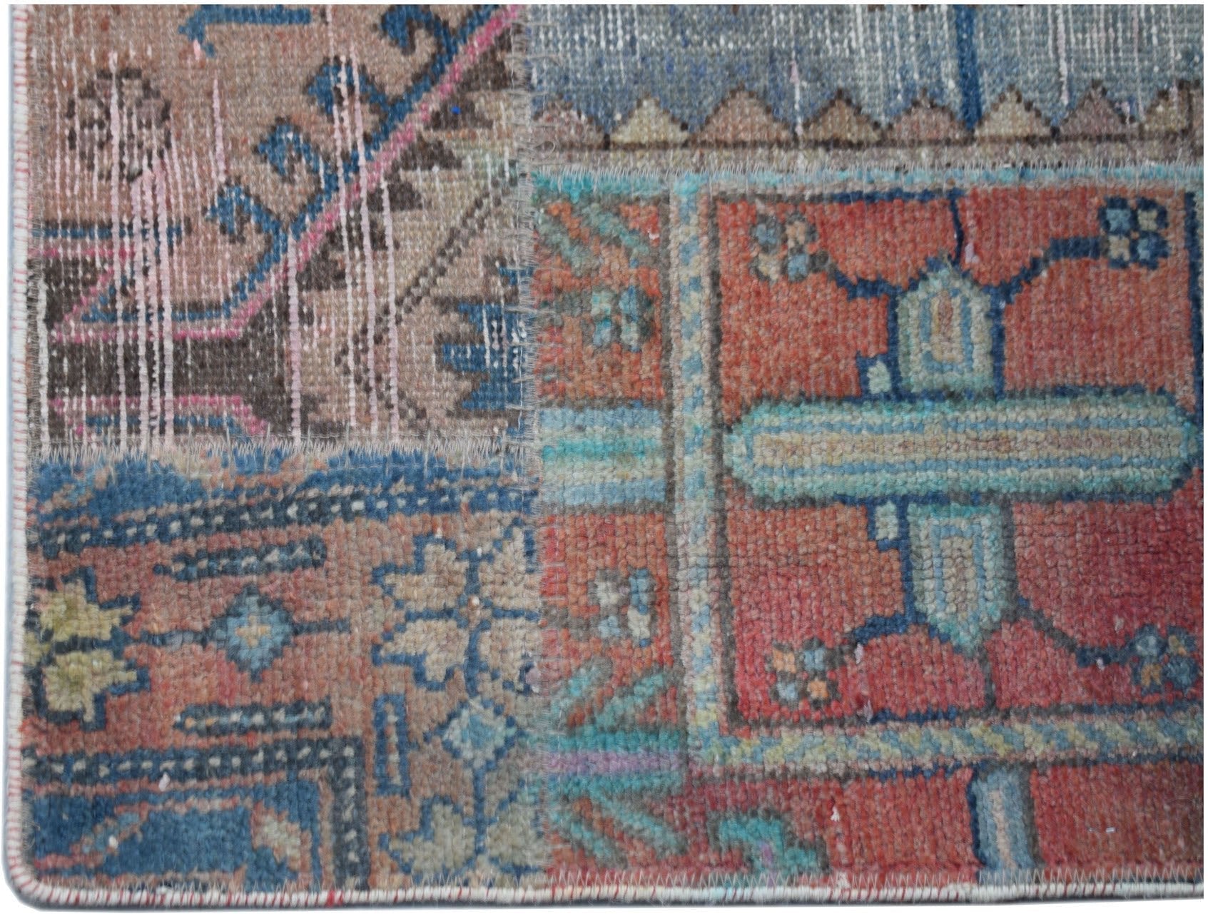 A handmade vintage patchwork runner featuring a colorful geometric pattern in wool.