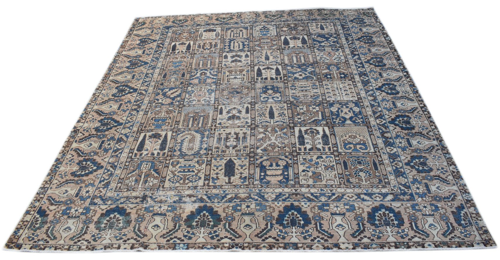 A handmade vintage Persian Bakhtiari rug featuring a blue and beige grid of floral garden motifs.