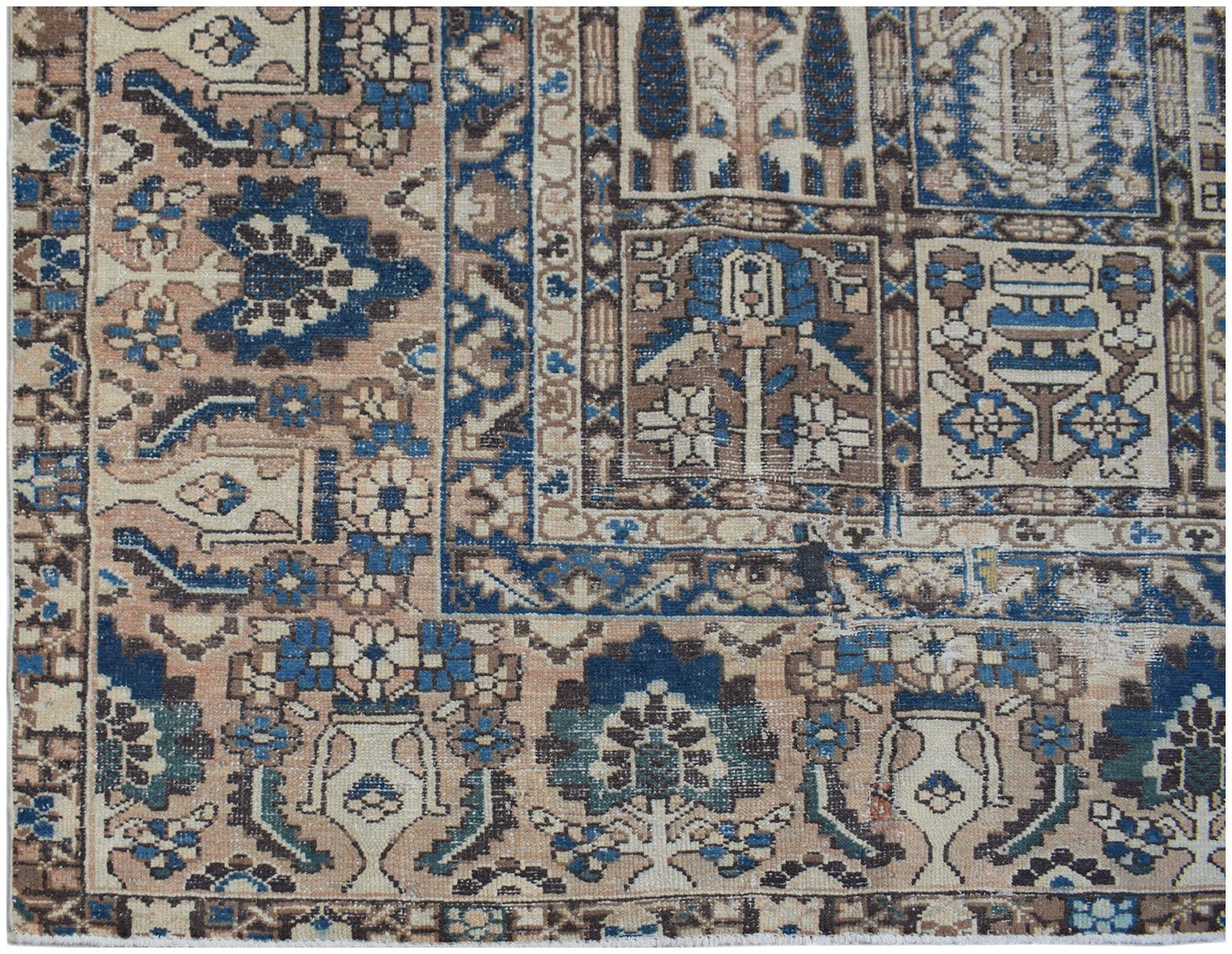 A vintage Persian Bakhtiari rug featuring a geometric garden panel design in blue and tan tones.