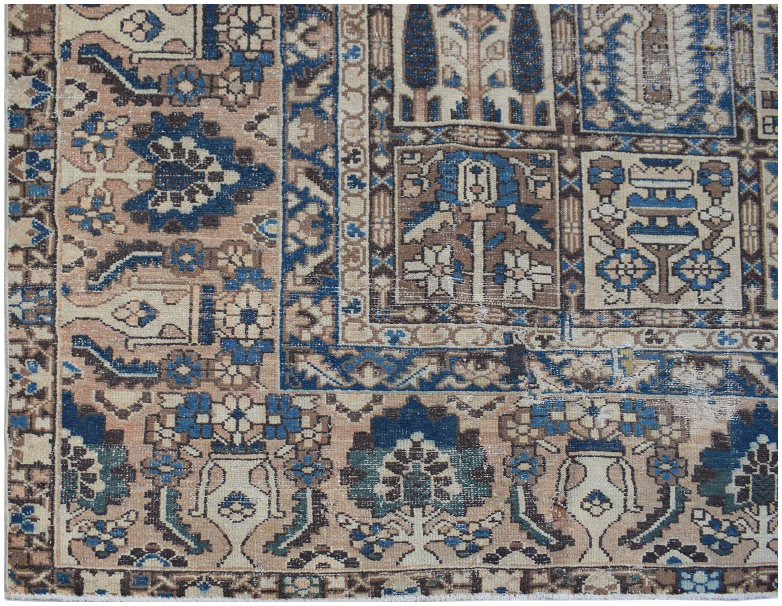 A vintage Persian Bakhtiari rug featuring a geometric garden panel design in blue and tan tones.