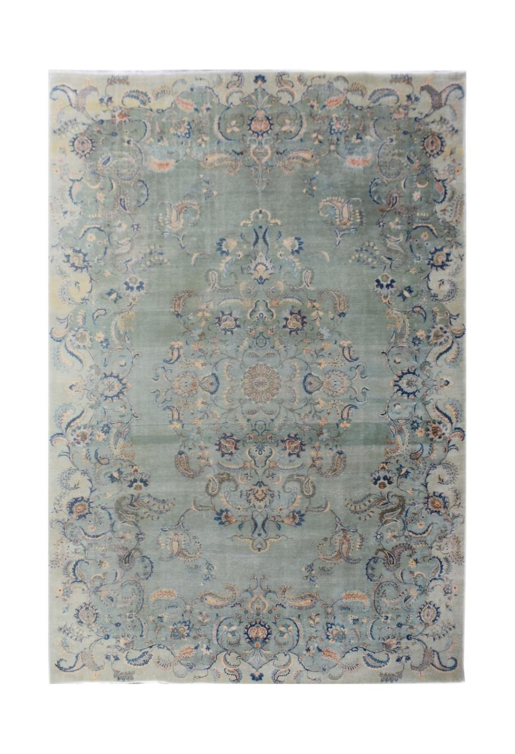 A vintage Persian Kashan rug featuring a central floral medallion on a light blue field.