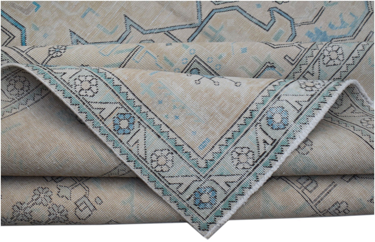 A vintage Persian Kerman rug featuring a beige field with intricate blue floral and medallion motifs.