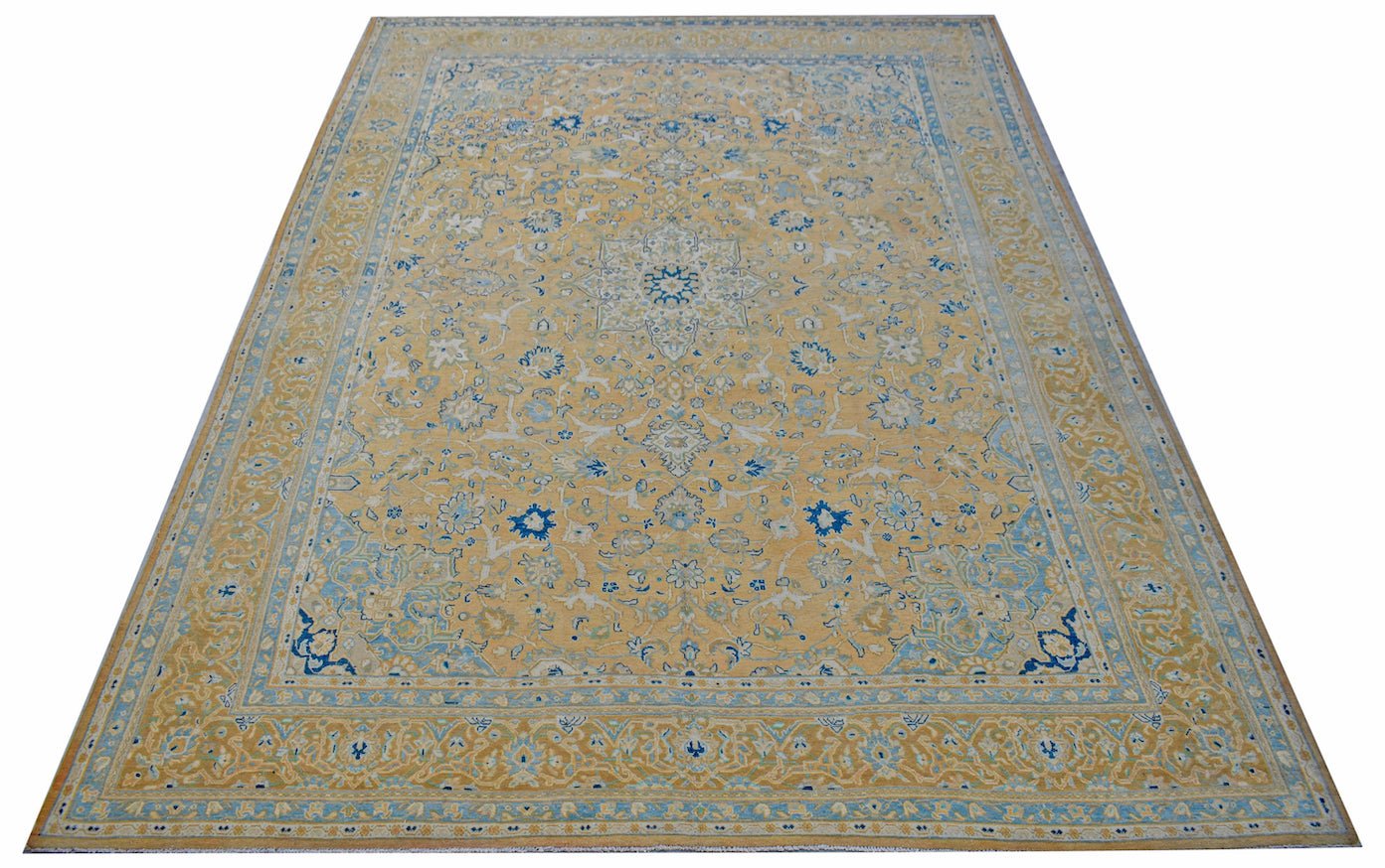 A vintage Persian Kashan rug featuring a central medallion and intricate floral patterns in blue.