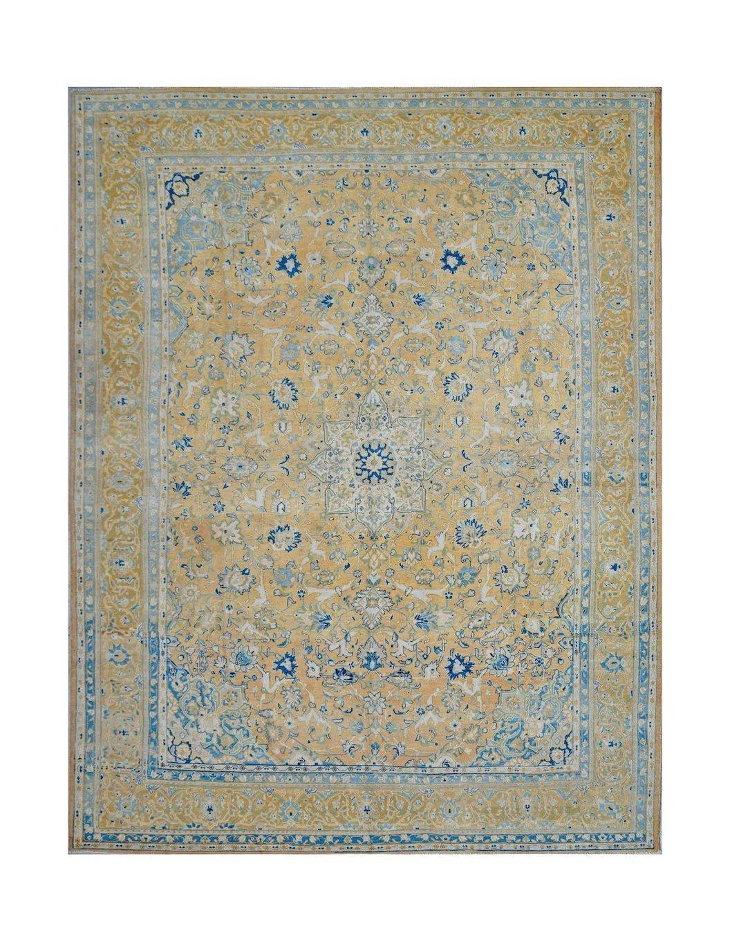 A vintage Persian Kashan rug featuring a central medallion and floral motifs in blue and gold.