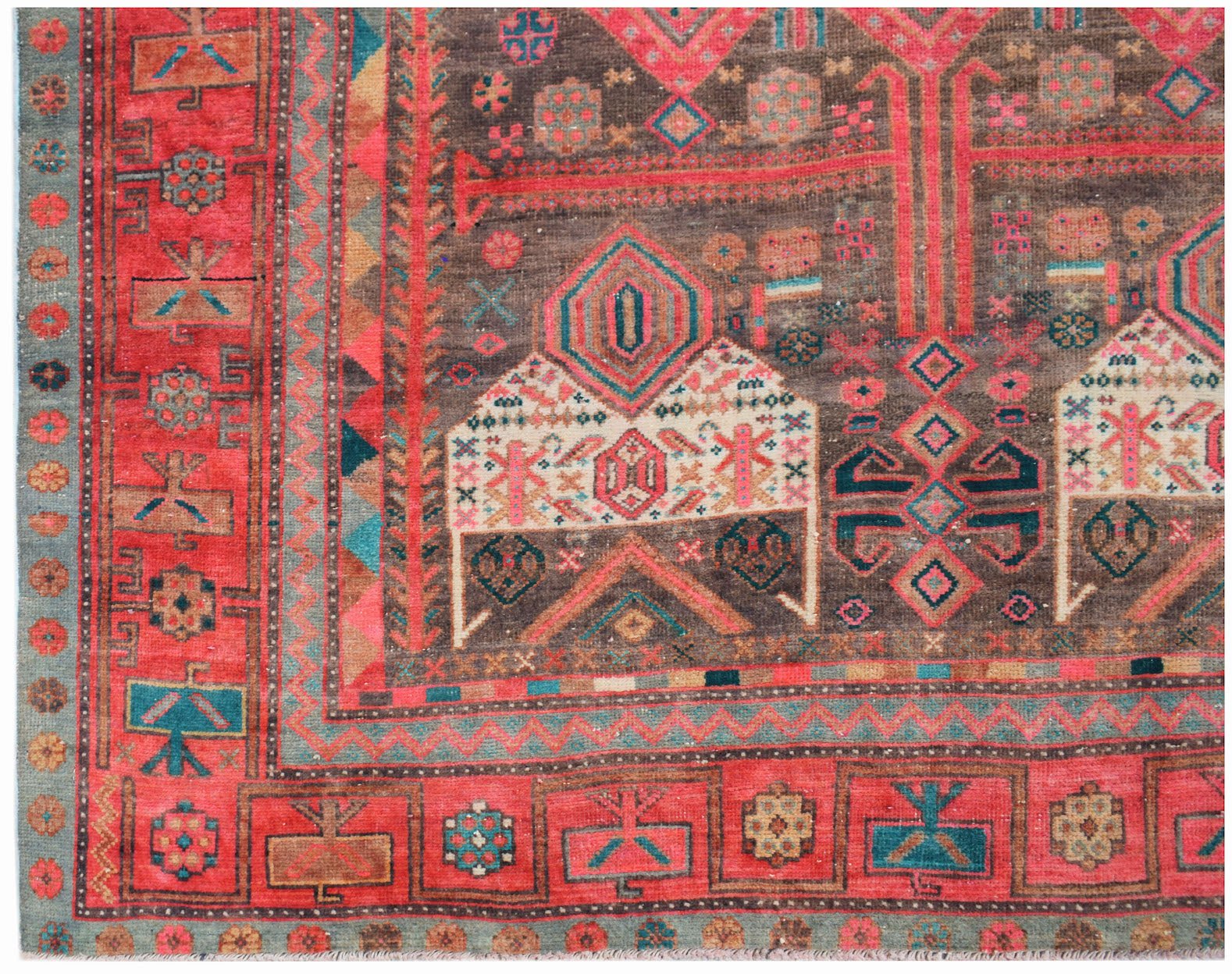 A vintage Persian Koliai rug featuring a brown field with a geometric Throne of Jamshed pattern.