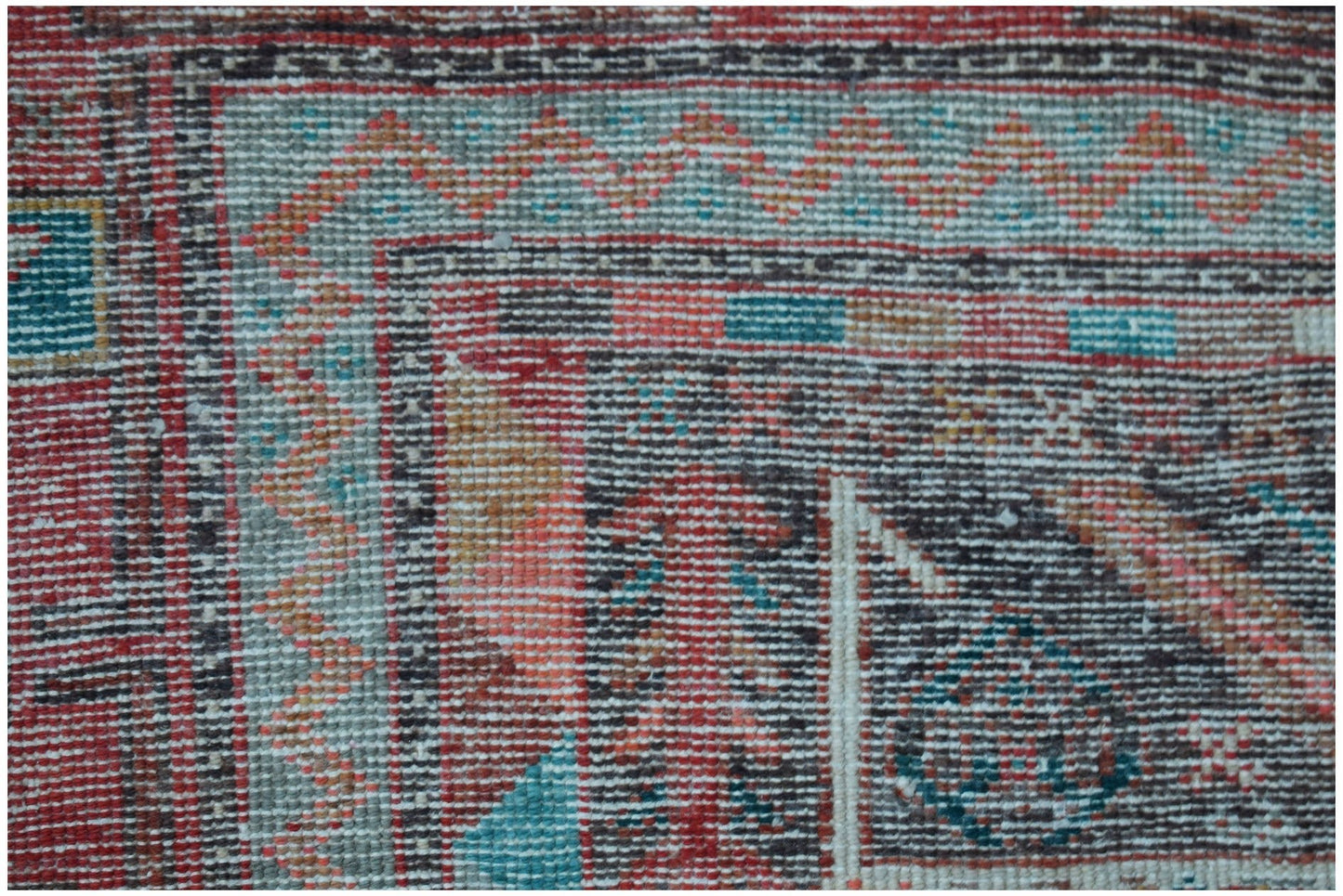 A close-up of a vintage Persian Koliai rug featuring a geometric Throne of Jamshed pattern.
