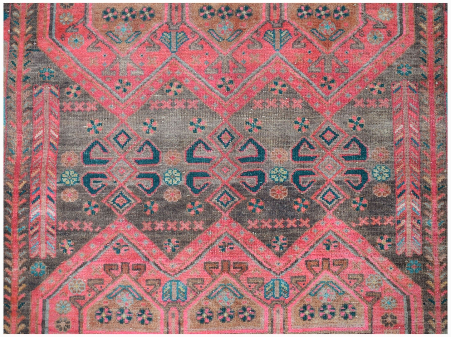 A vintage Persian Koliai rug featuring a geometric Throne of Jamshed pattern in red and brown tones.