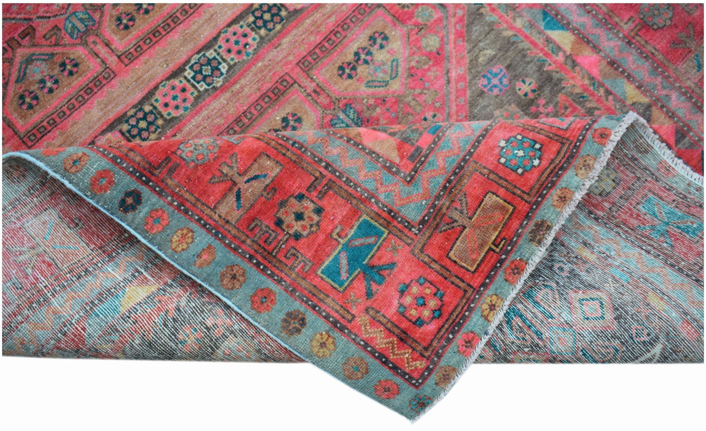 A vintage Persian Koliai rug featuring a red and blue geometric Throne of Jamshed pattern.