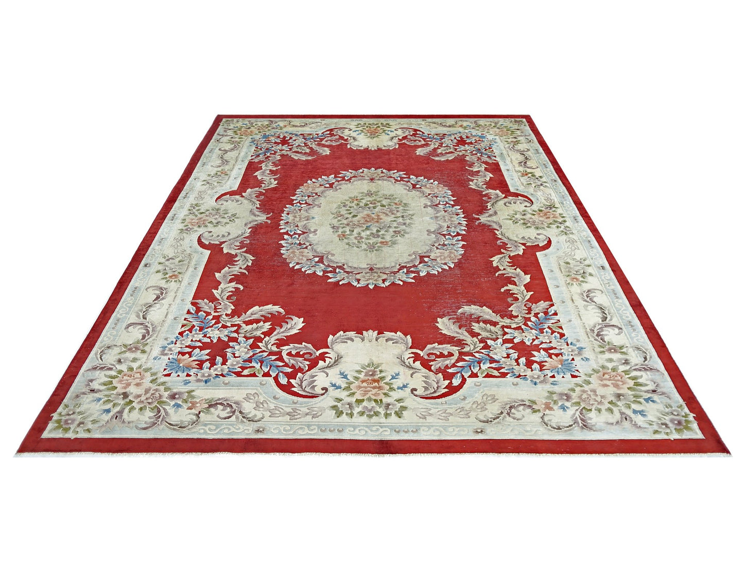 A vintage handmade Chinese silk rug featuring a floral medallion on a red field.