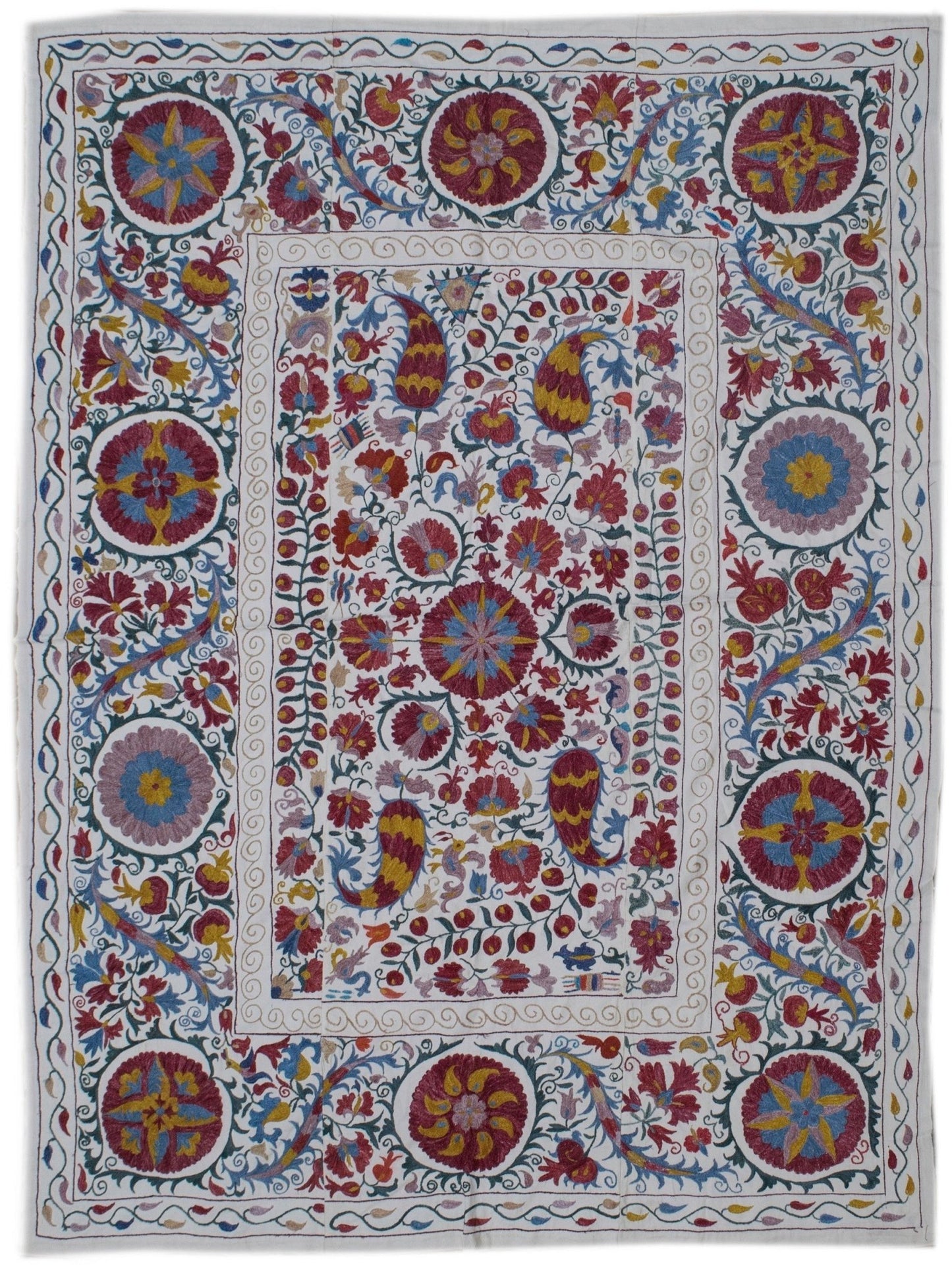 Handmade Uzbek suzani featuring intricate silk floral and paisley embroidery on a cotton base.