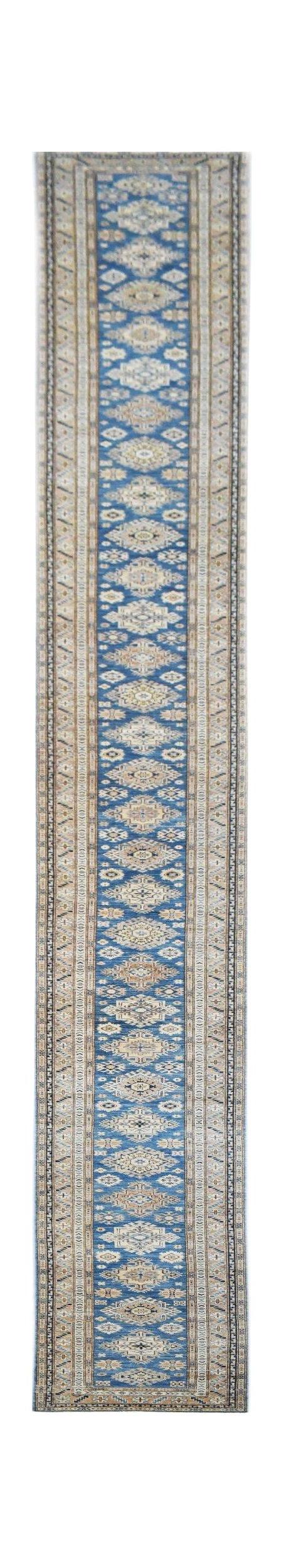 A long, handmade Afghan Super Kazakh runner rug featuring traditional geometric motifs in blue.