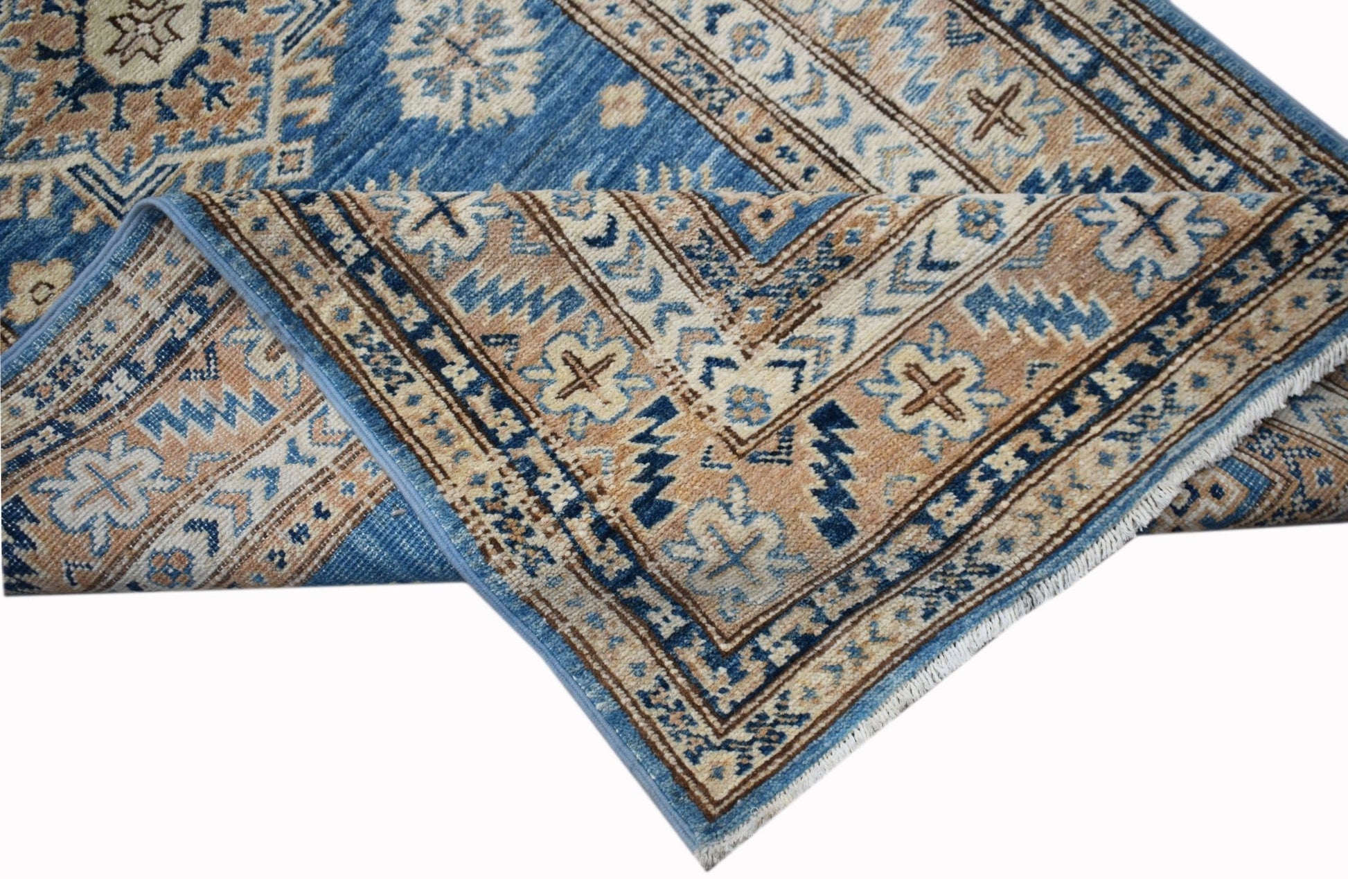 A handmade Afghan Super Kazakh runner featuring traditional blue and tan geometric patterns.