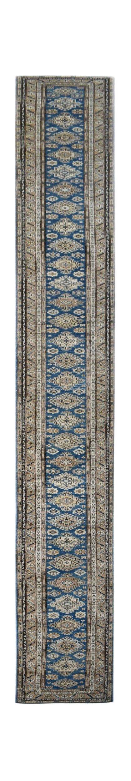 A handmade Afghan Super Kazakh runner rug featuring traditional geometric motifs in blue and tan.