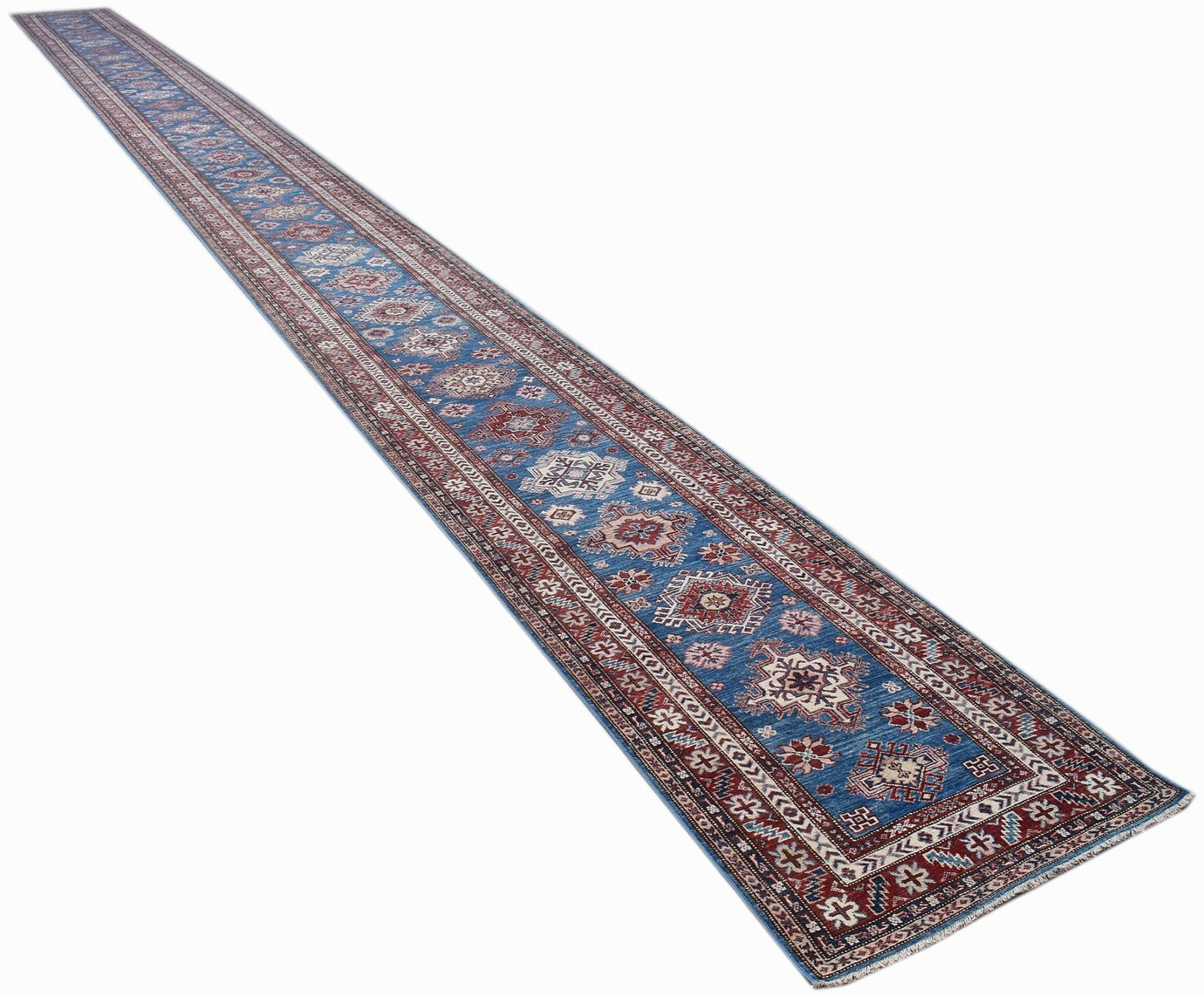 A long, handmade Afghan Super Kazakh runner rug featuring traditional geometric motifs in blue.