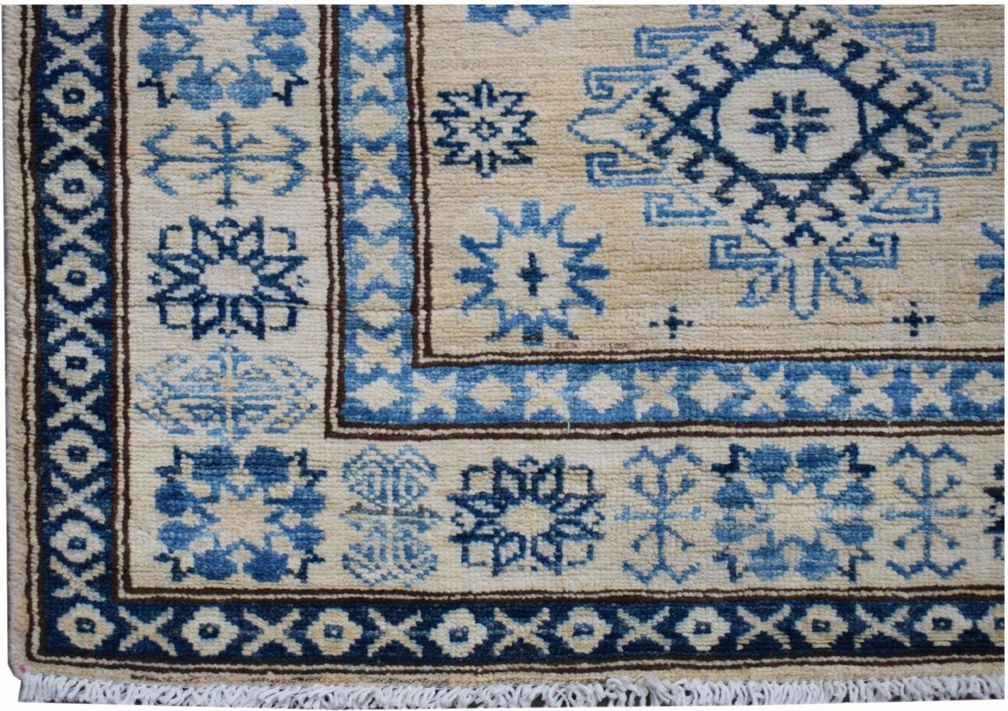 Handmade Afghan Super Kazakh runner rug featuring blue geometric patterns on a beige wool field.