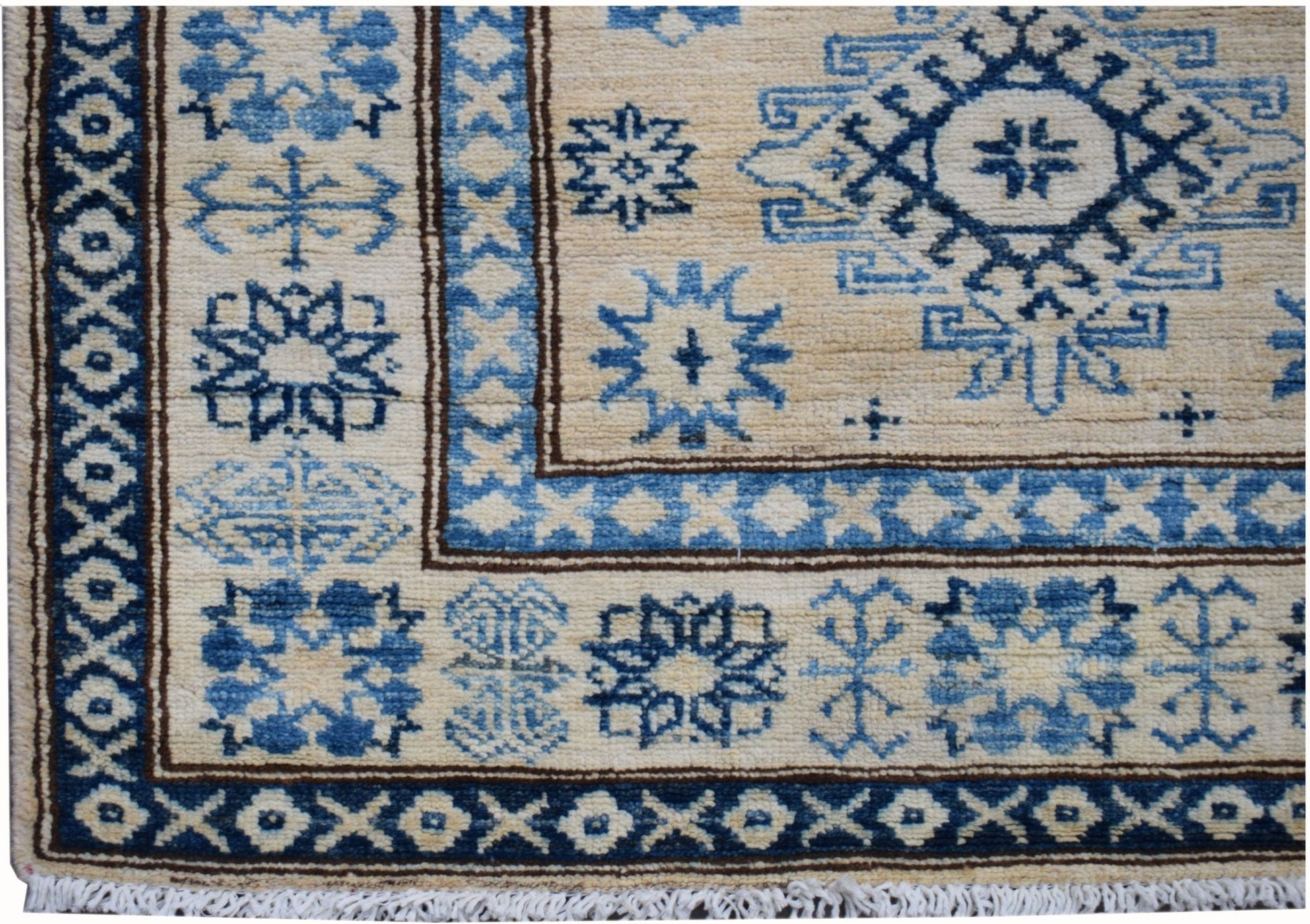 Handmade Afghan Super Kazakh runner rug featuring blue geometric patterns on a beige wool field.