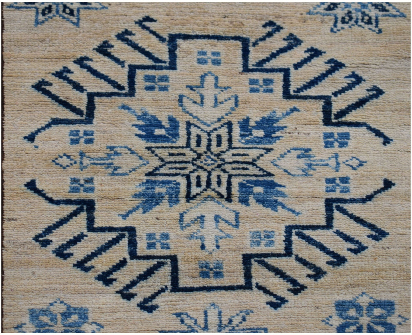 Handmade Afghan Super Kazakh runner rug featuring a blue geometric medallion on a beige field.