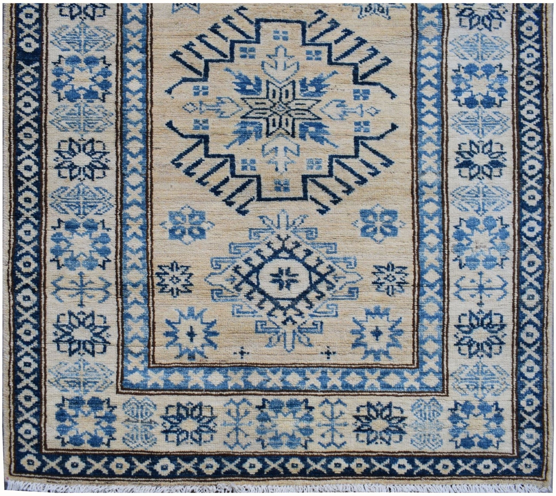 Handmade Afghan Super Kazakh runner rug featuring blue geometric patterns on a beige wool field.