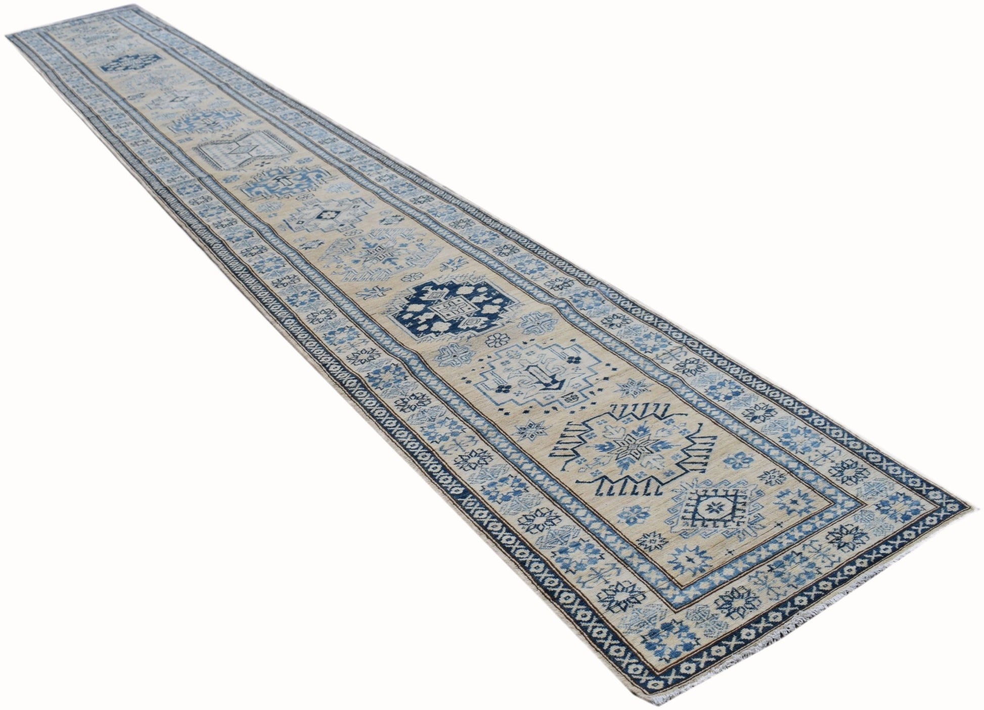 A long, handmade Afghan Super Kazakh runner rug featuring geometric patterns in blue and beige.