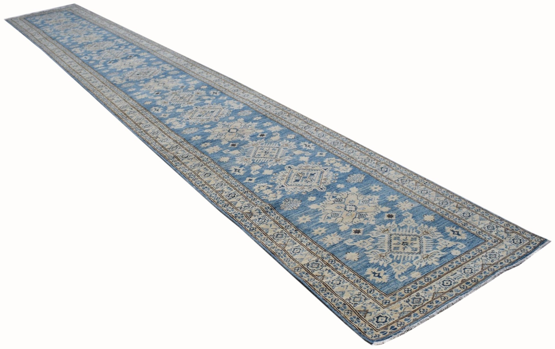 A long, handmade Afghan Super Kazakh runner rug featuring intricate blue and beige geometric patterns.