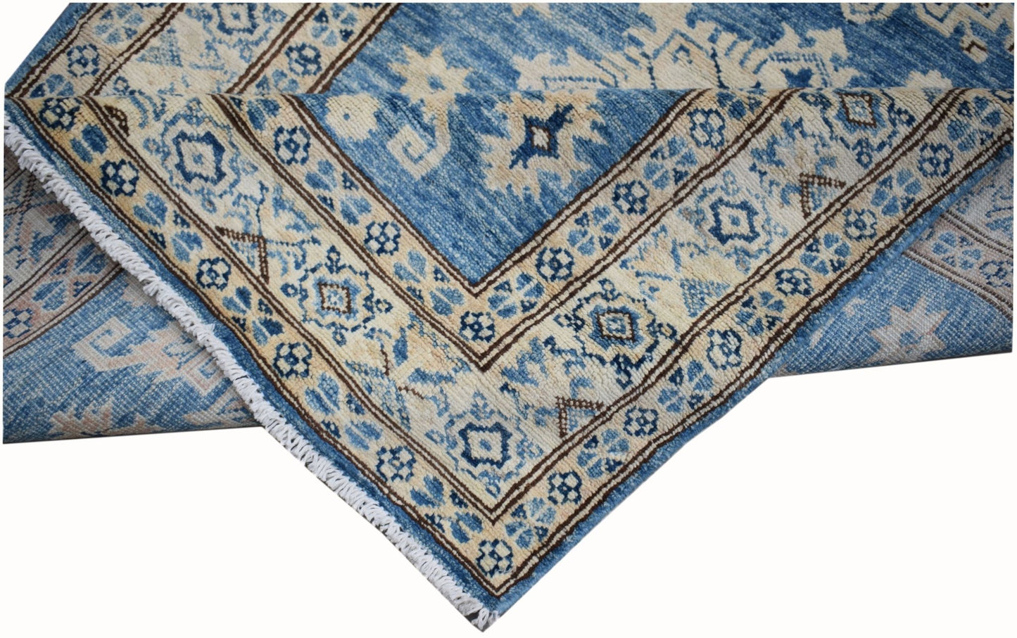 A handmade Afghan Super Kazakh runner rug featuring a blue and beige geometric pattern.