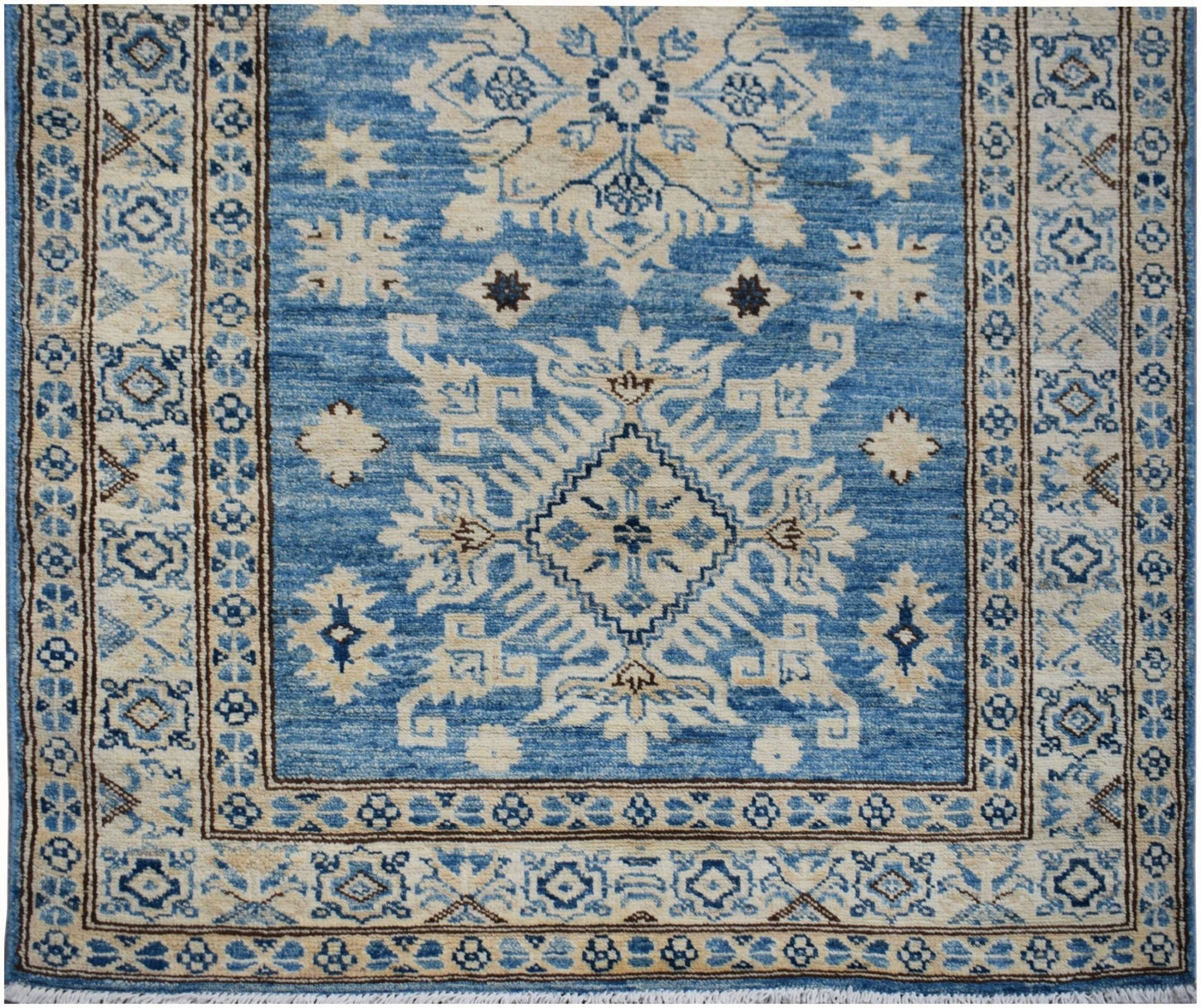 Handmade Afghan Super Kazakh runner rug featuring a blue field with beige geometric motifs.