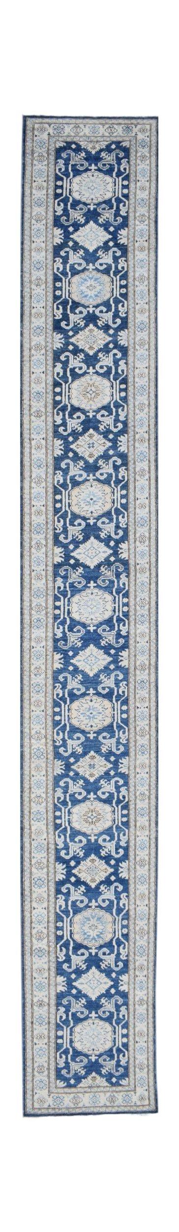 A long, handmade Afghan Super Kazakh runner rug featuring a repeating blue and beige geometric pattern.