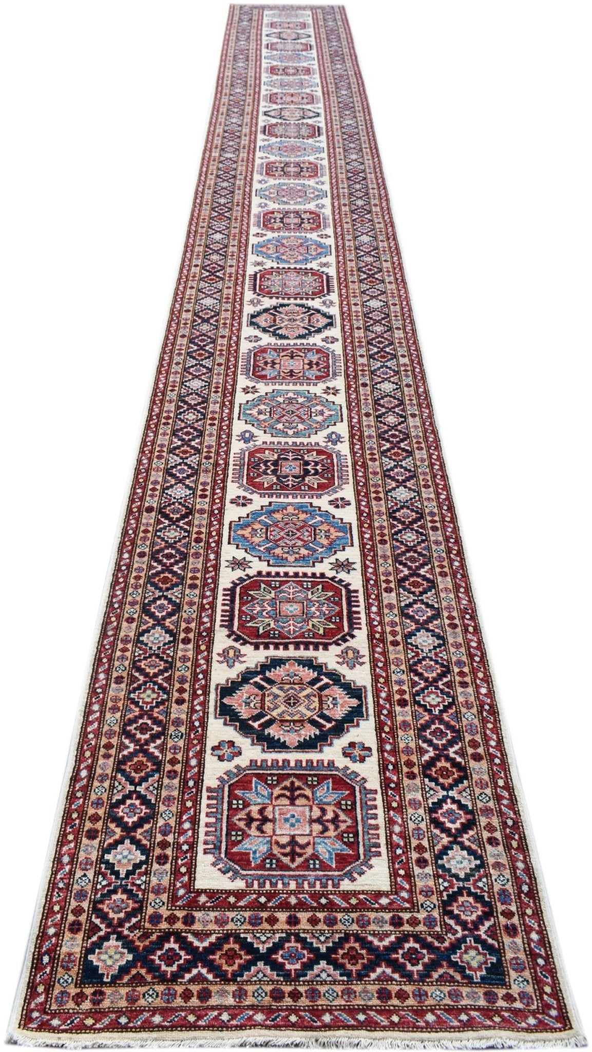 A long, handmade Afghan Super Kazakh runner rug featuring traditional geometric motifs in wool.