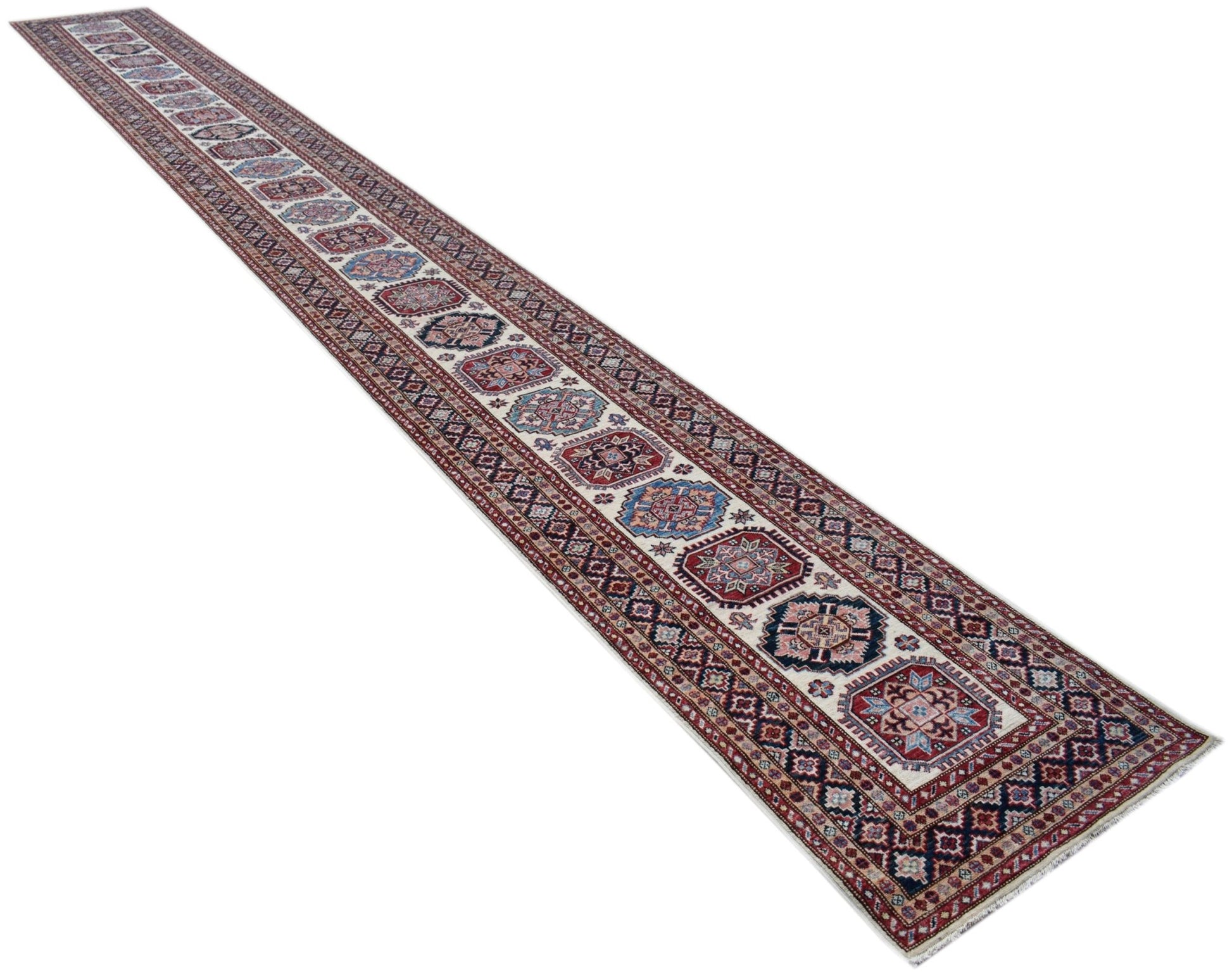 A long, handmade Afghan Super Kazakh runner rug featuring traditional geometric motifs in wool.