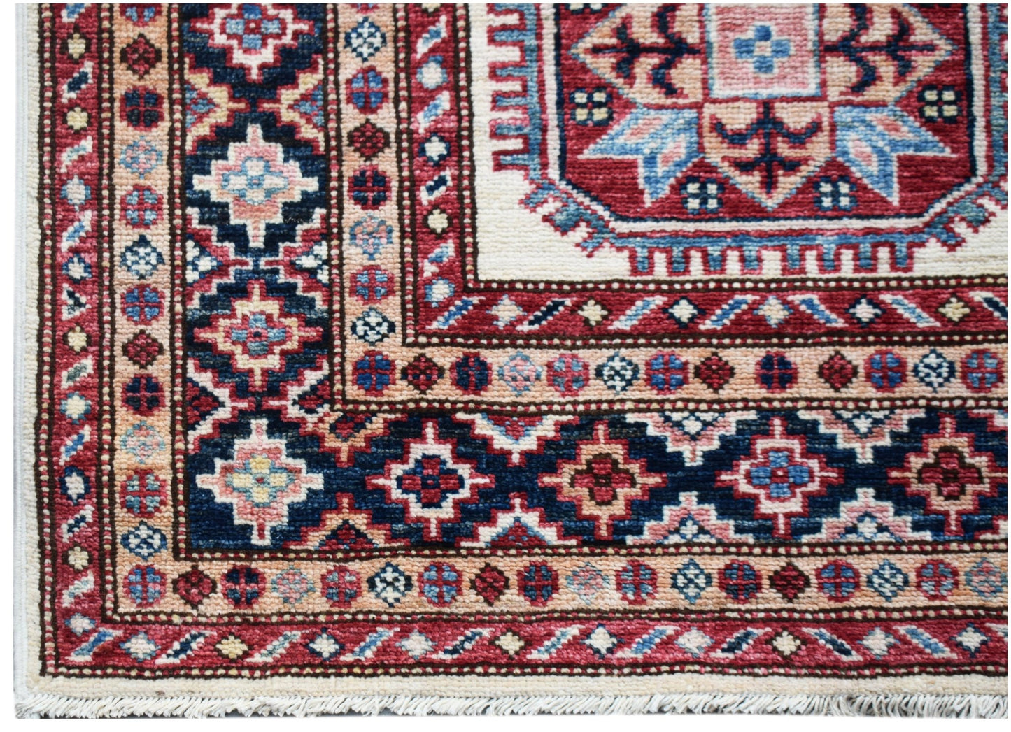 A handmade Afghan Super Kazakh runner featuring traditional geometric motifs in red and blue.