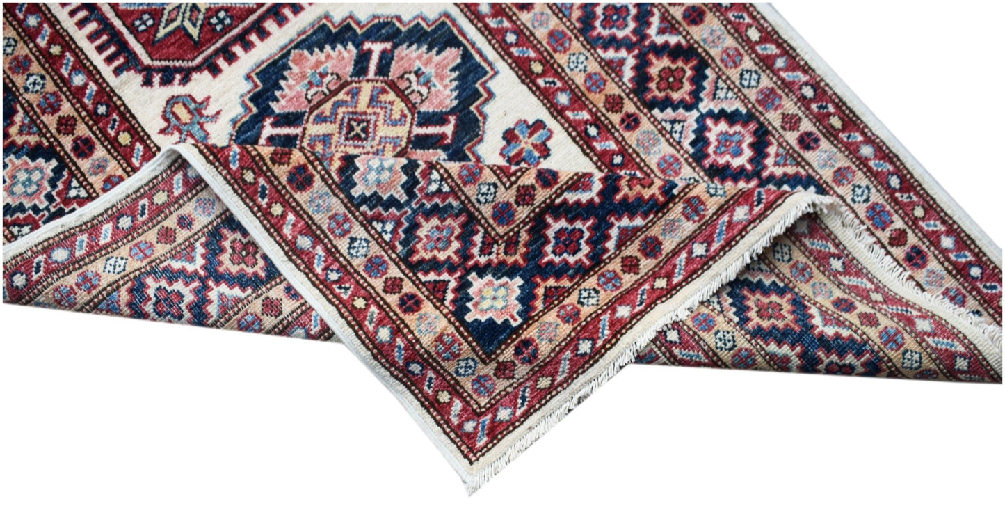 A handmade Afghan Super Kazakh runner featuring traditional geometric motifs in red and blue.