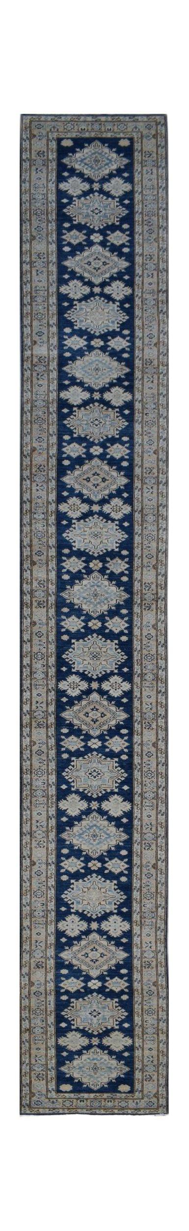 An Afghan Super Kazakh runner rug featuring a repeating geometric pattern in blue, beige, and grey.