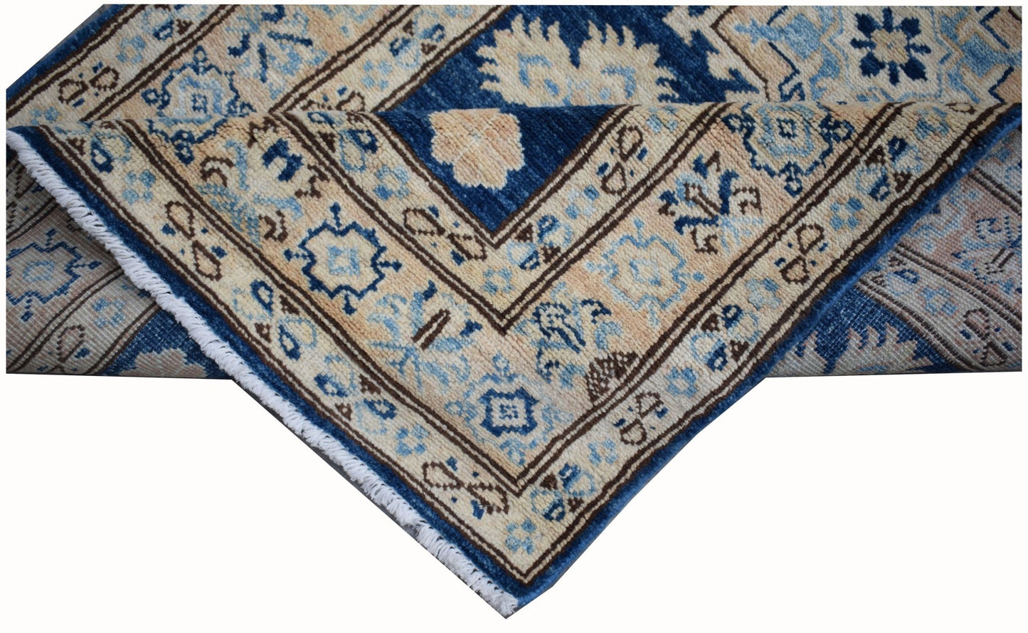 A handmade Afghan Super Kazakh runner featuring a geometric pattern in blue and beige wool.