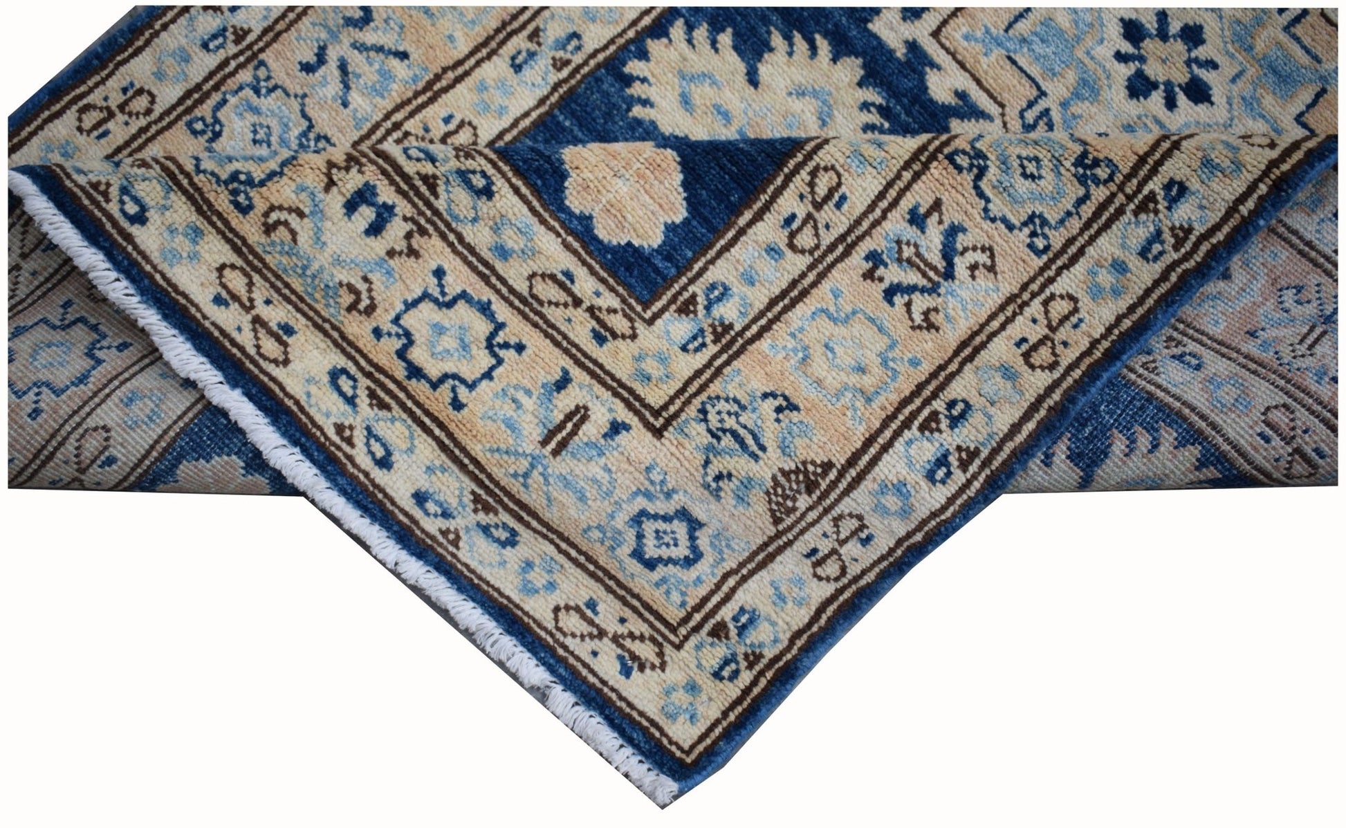 A handmade Afghan Super Kazakh runner featuring a geometric pattern in blue and beige wool.